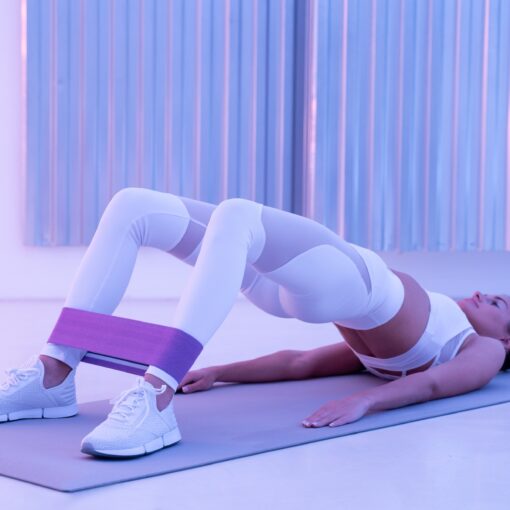 Sporty Female Fitness Trainer Doing Hip Workout Or Pelvic Floor Exercises On Yoga Mat