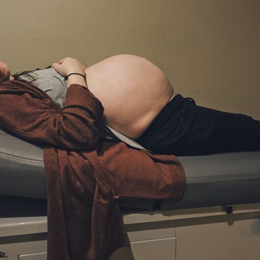 A Young Woman Is Visiting Her Midwife For A Checkup Before She Goes Into Labor