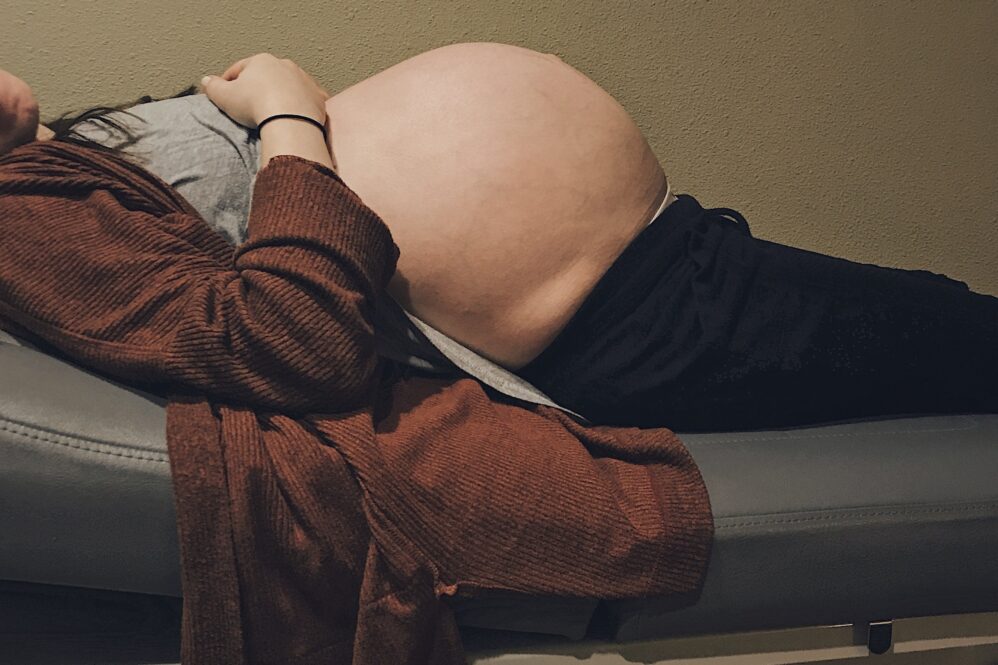 A Young Woman Is Visiting Her Midwife For A Checkup Before She Goes Into Labor