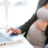 Pregnant Woman Working On Laptop.